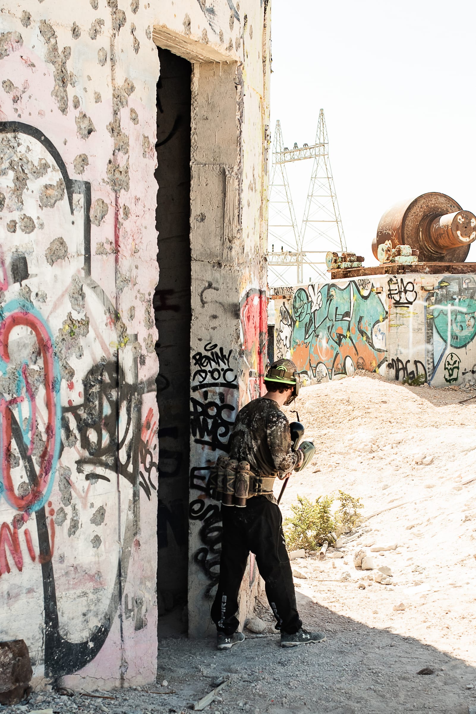 A player slipping through a graffiti-covered doorway